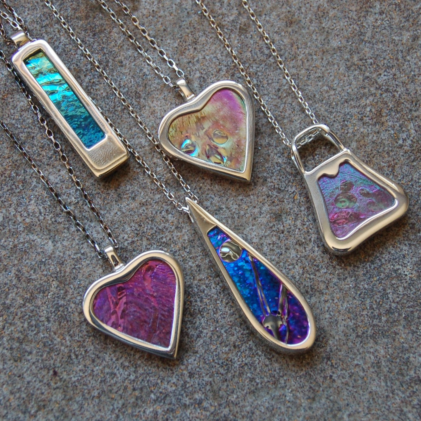 Hallmarked sterling silver pendants with memorial glassand ashes @ £180 each.