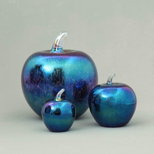 set of handmade glass apples in dark iridescent