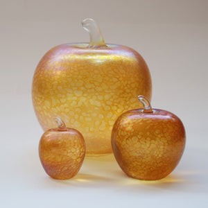 Handmade glass apples in iridescent gold