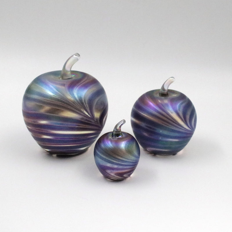 Handmade glass apples with an iridescent feathered pattern