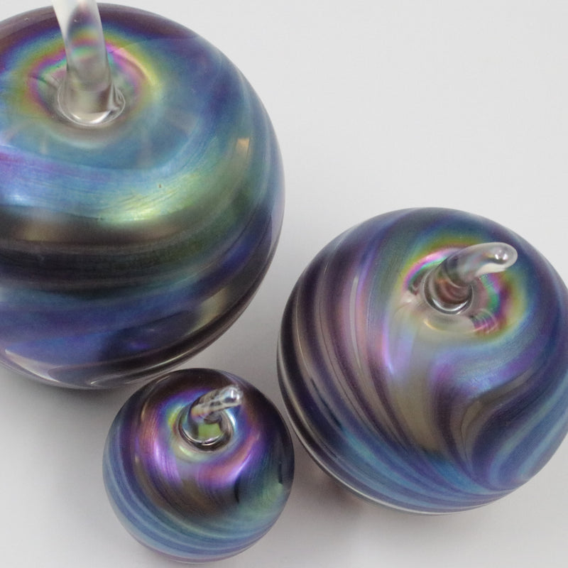 Handmade glass apples with an iridescent feathered pattern