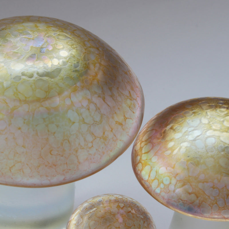 close up of handmade glass mushrooms in gold