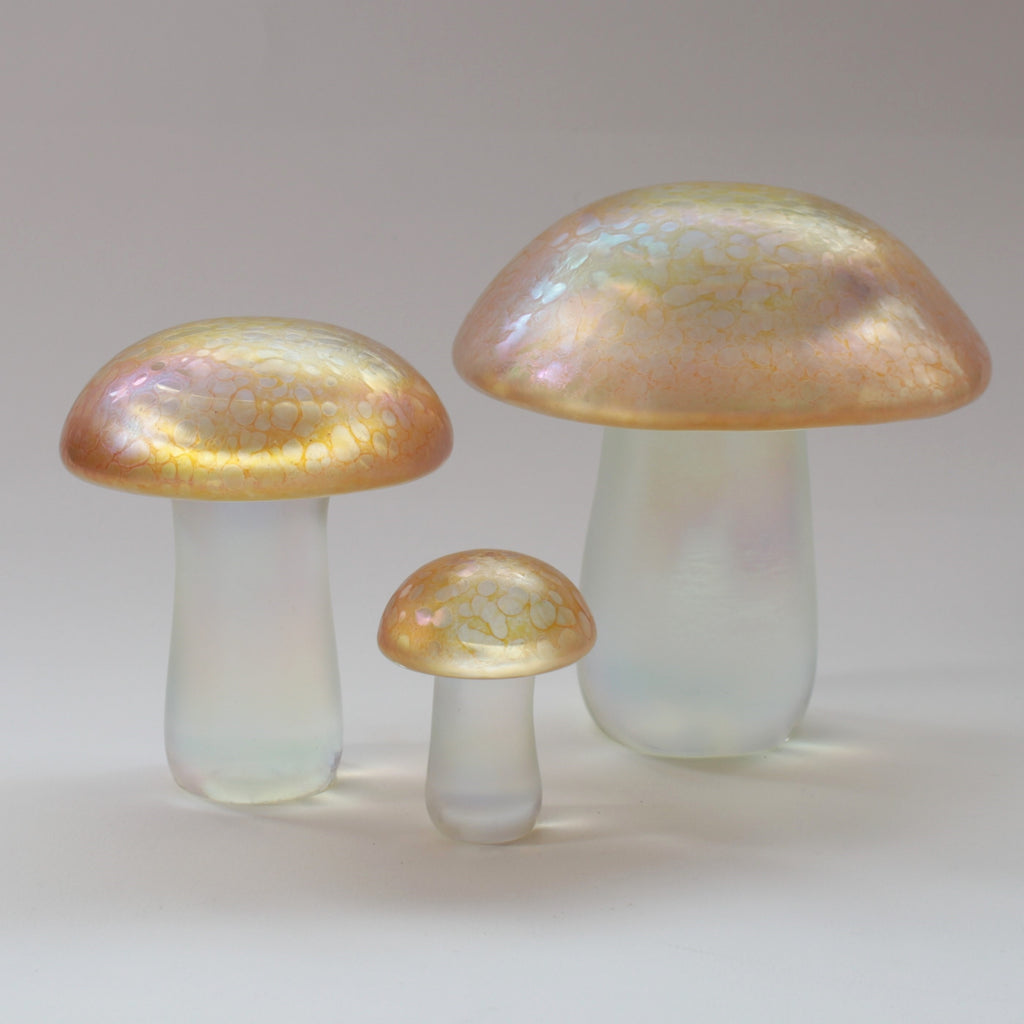 set of handmade glass mushrooms in iridescent gold