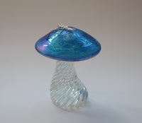 silver dragonfly resting on an iridescent aquamarine capped handmade glass toadstool