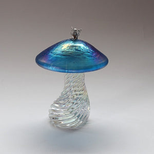 Silver fairy sitting on a handmade glass iridescent aquamarine toadstool 