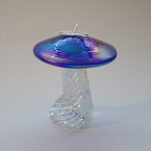 silver dragonfly resting on an iridescent cobalt blue  capped handmade glass toadstool