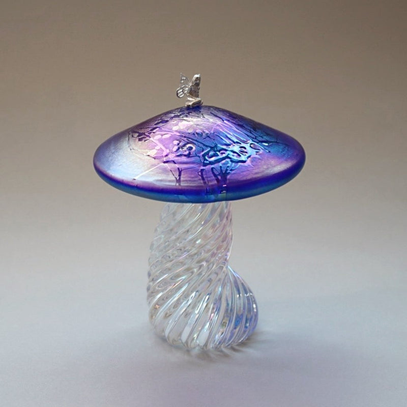 Silver fairy sitting on a handmade glass iridescent cobalt blue toadstool 
