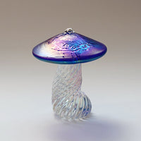 silver frog sitting on an iridescent cobalt blue handmade glass toadstool