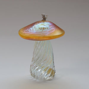 silver fiary sitting on an iridescent gold capped handmade glass toadstool 