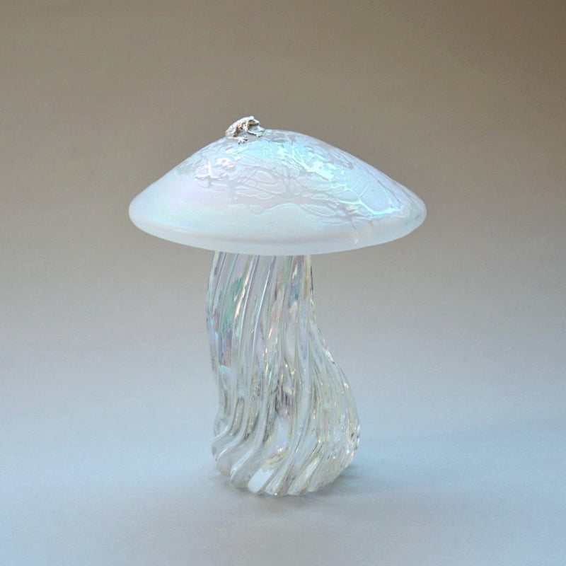 silver frog sitting on an pearl iridescent handmade glass toadstool