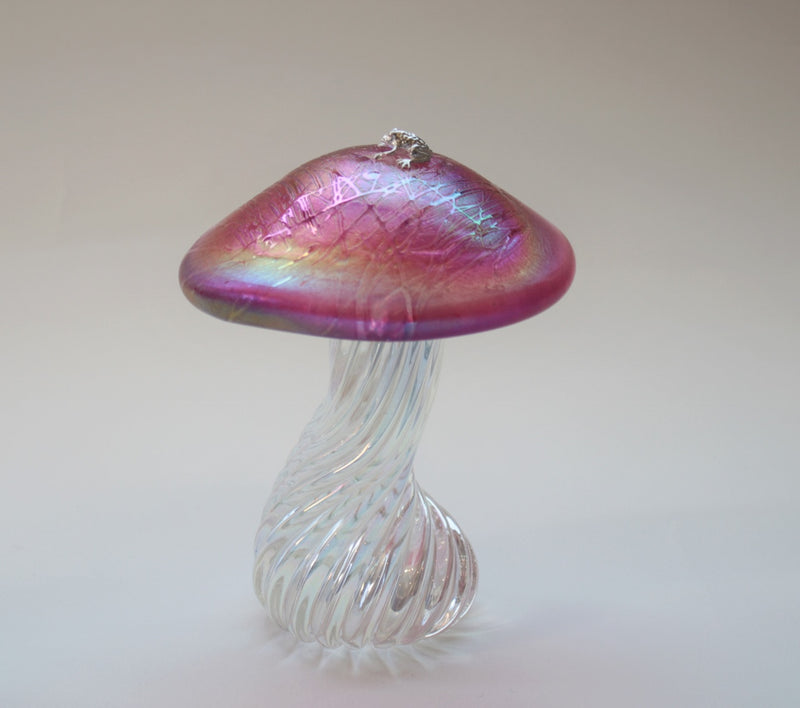 silver frog sitting on an iridescent pink handmade glass toadstool